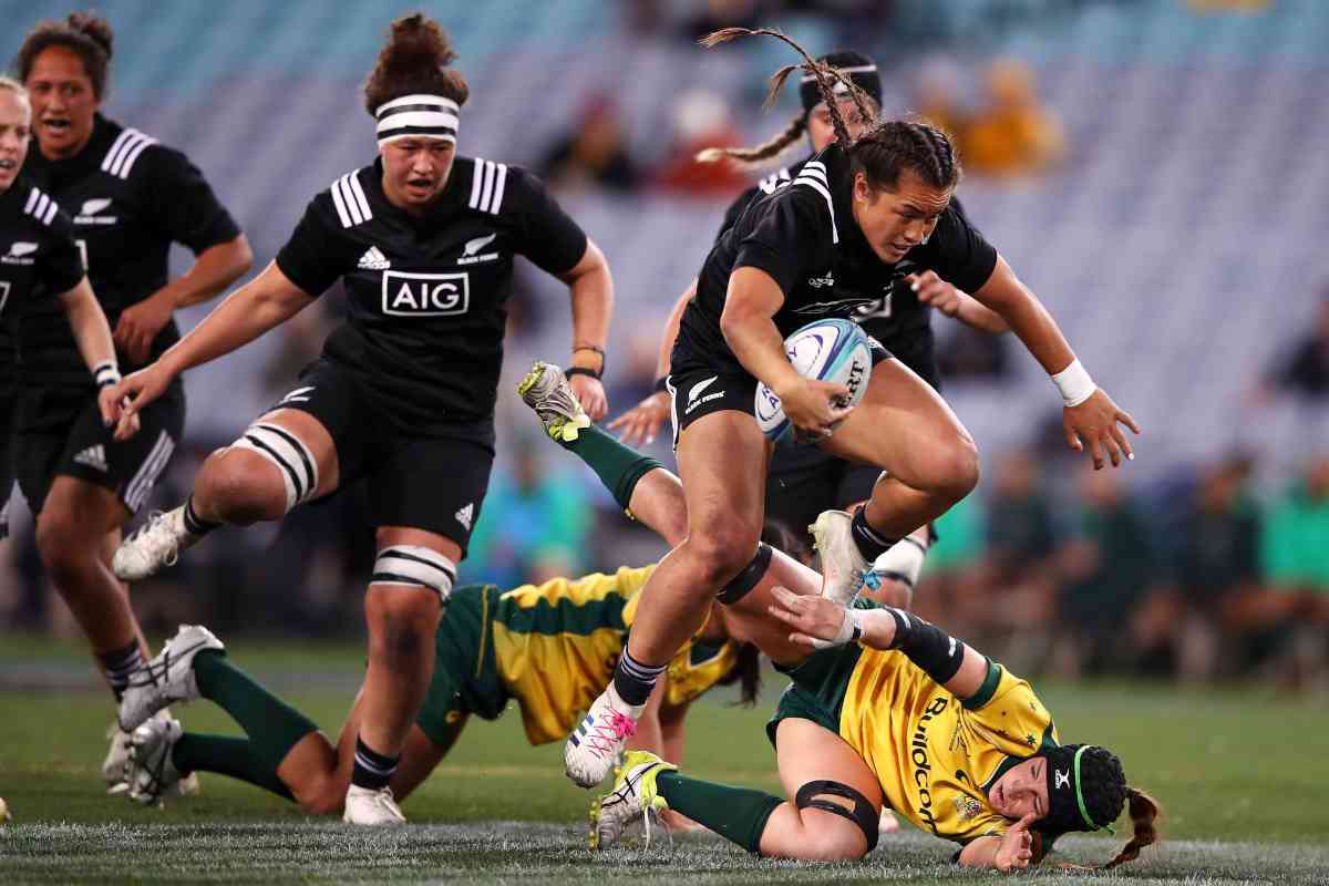 Black Ferns players running and jumping